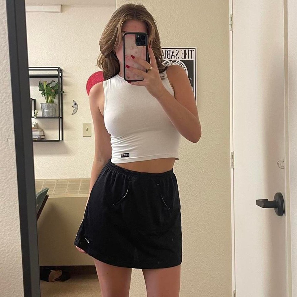 the black nike athletic mesh mini skirt with nike logo by the hem